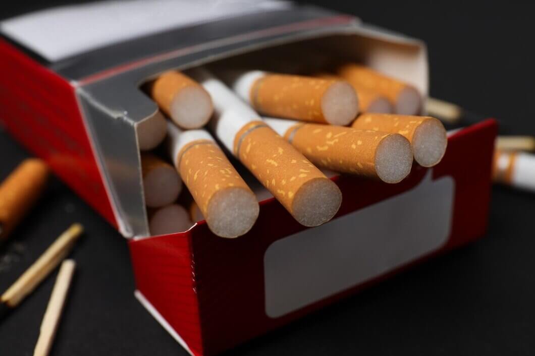 pack-cigarettes-with-matches-dark-background_185193-163238
